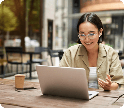 stocky-female-at-table-with-laptop-airpods-in-ear